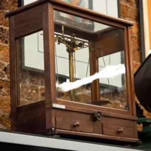 Vintage collectable scientific scales in wooden display case.