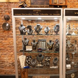 Gold jewellery display containing necklaces, bracelets and pendants and Monty's jewellery shop.