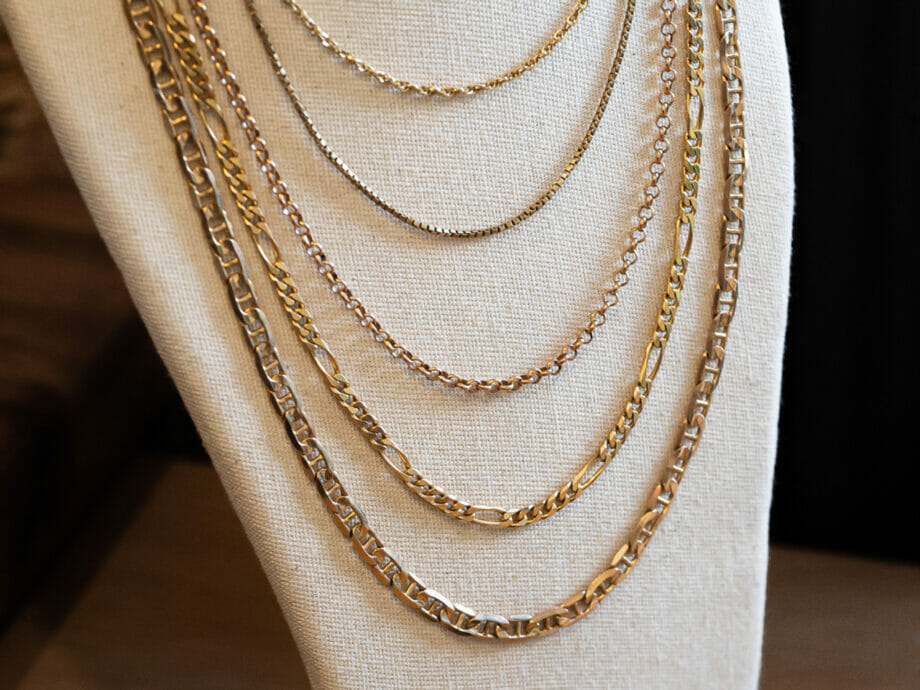 Different gold necklace chain designs displayed on together.
