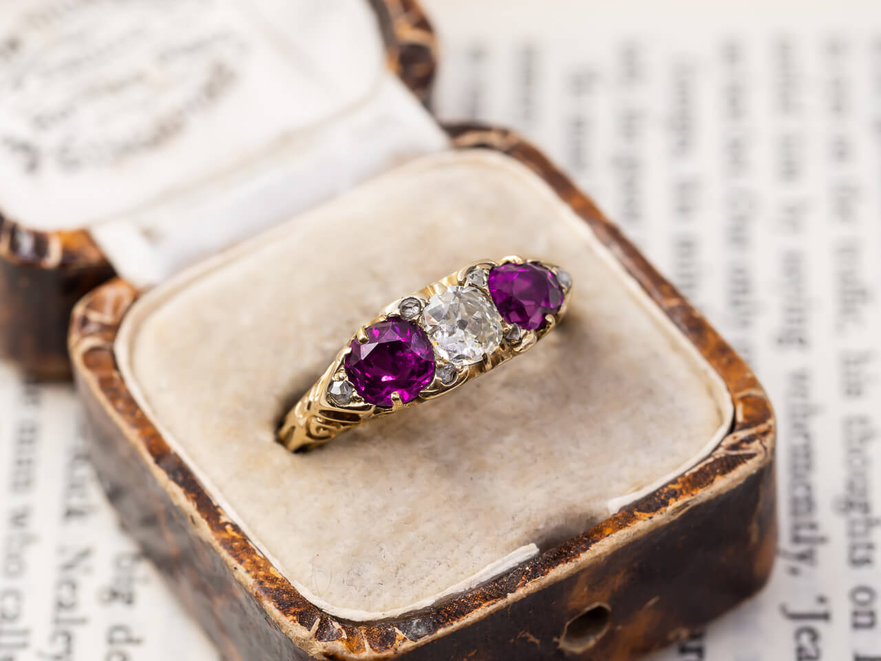 A pink gemstone engagement ring with a vintage design.