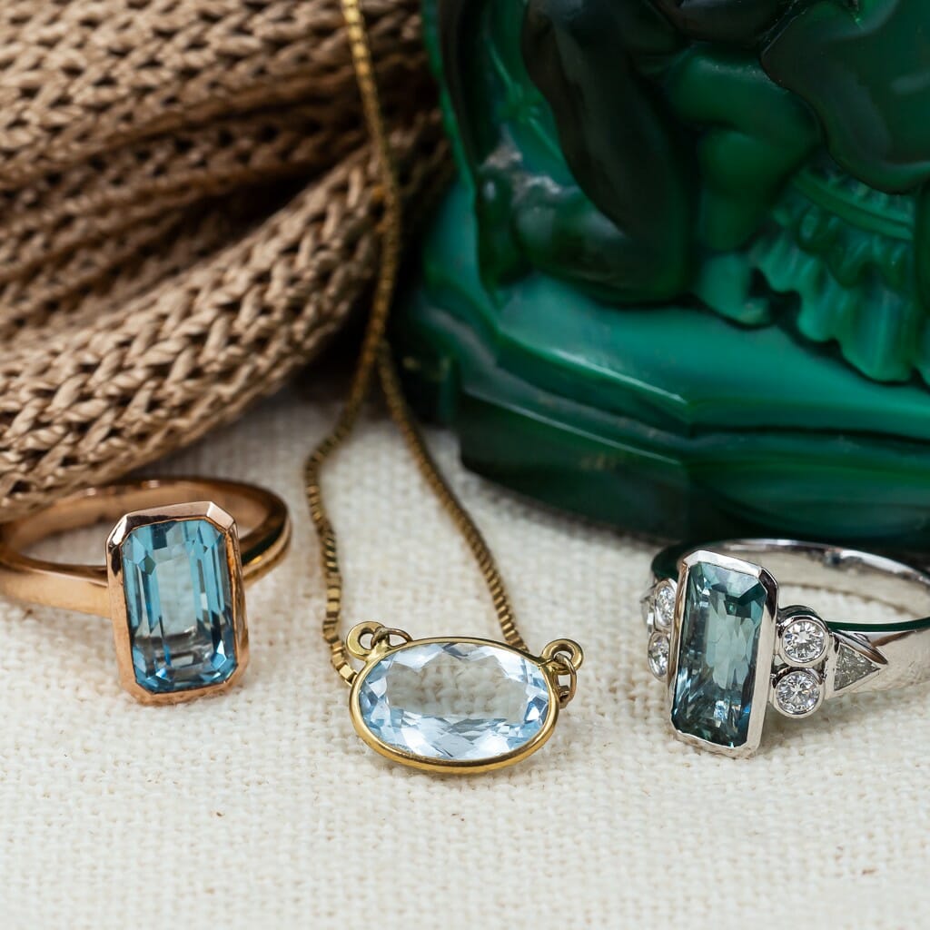 The Birthstone for March set in rings and a pendant.