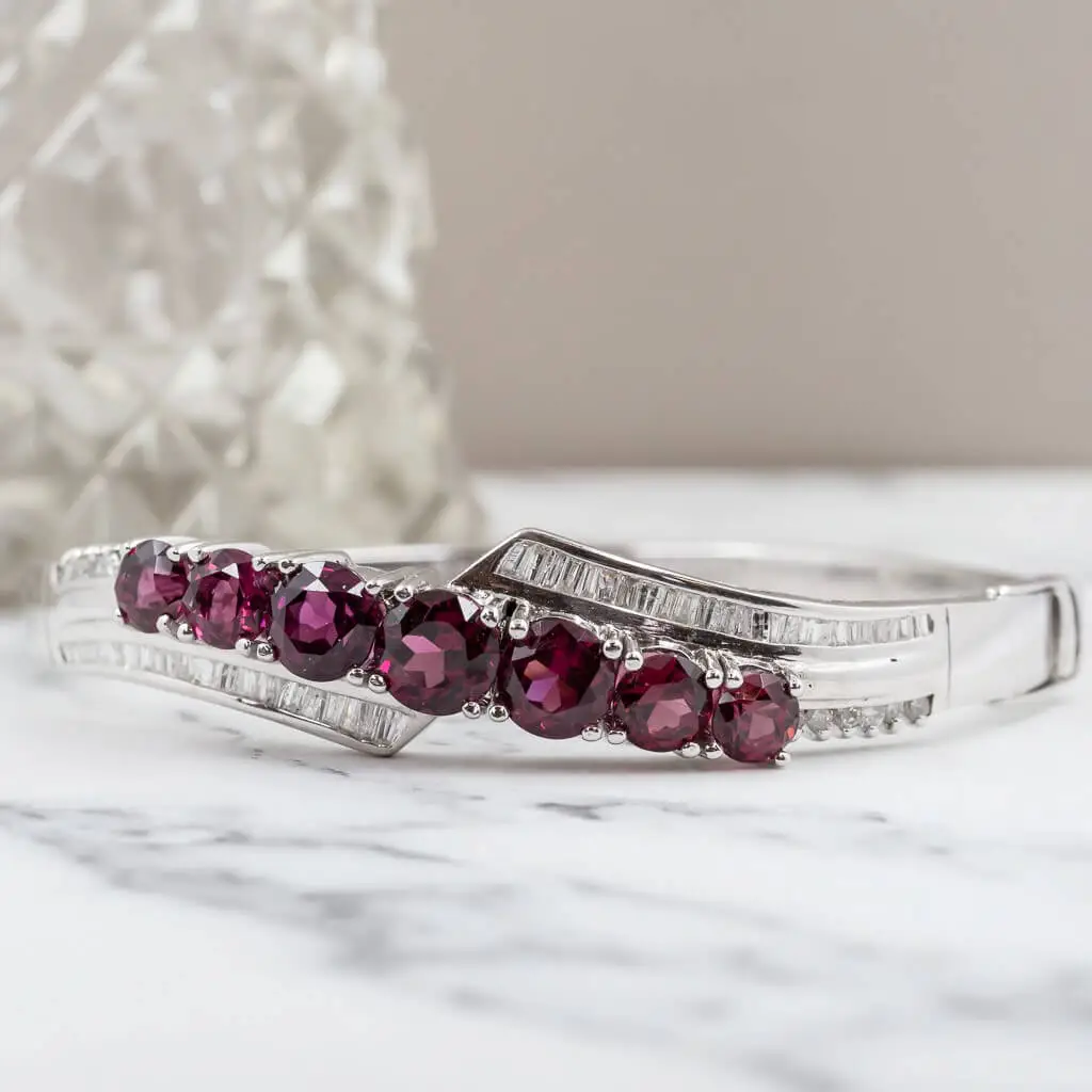 Garnet and white gold bangle representing the month of January.