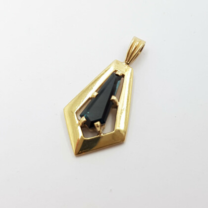 This stunning pendant has a tapered, fancy cut Sapphire with a lovely dark greenish blue colour and is made from 9ct gold.